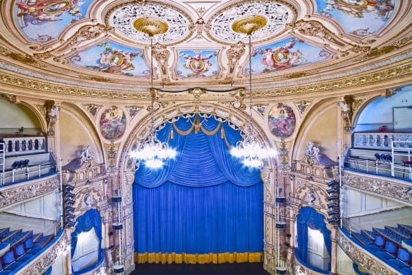 Blue drama curtain with golden bullion fringe