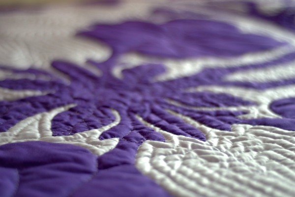 purple color quilts with stitched in thread look