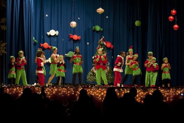 kids celebrating Christmas with blue colour stage backdrop