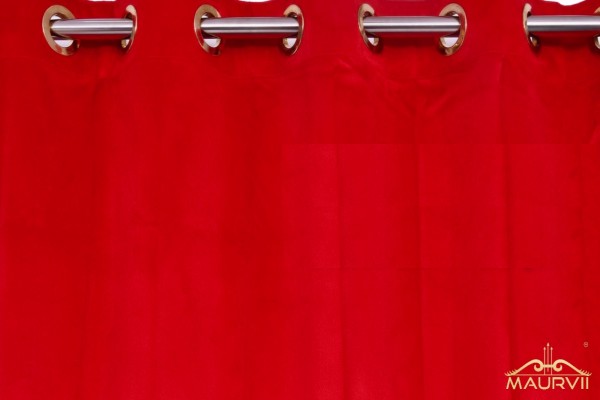 Red stage curtains are hanged with grommet using curtain rod