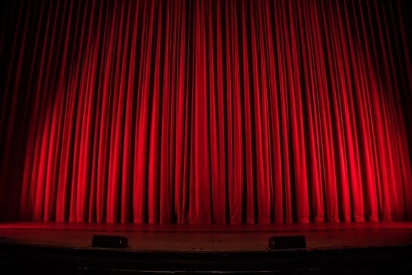 Red theatre curtain with more gathered look at stage